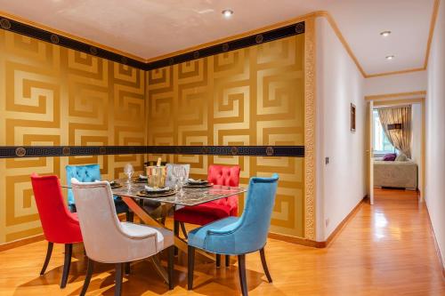a dining room with a table and colorful chairs at Spanish Steps amazing Apartment in Rome