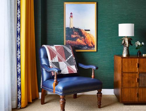 a blue chair with a pillow on it in a room at Graduate by Hilton Annapolis in Annapolis