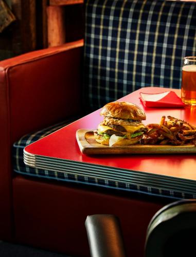 a sandwich on a plate on a table with fries at Graduate by Hilton Annapolis in Annapolis