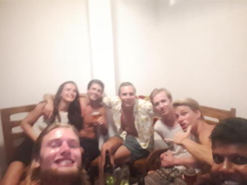 a group of people sitting on a bed at Lake View Villa in Mirissa