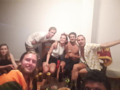 a group of people sitting in a room with bottles of wine at Lake View Villa in Mirissa