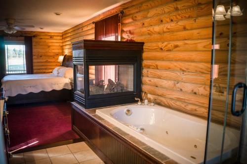 a bathroom with a bath tub in a log cabin at A Breath of Heaven B&B in Traverse City