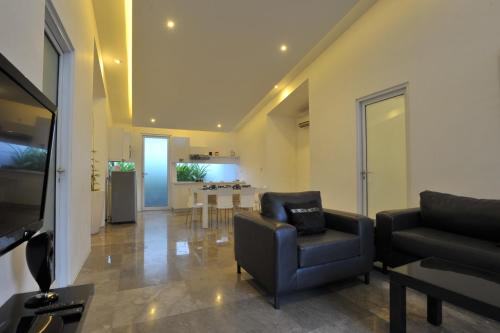 a living room with a couch and a chair at Bali Yarra Villas - Seminyak in Seminyak