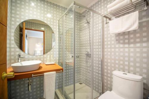 uma casa de banho com um chuveiro, um WC e um lavatório. em 202 Hotel Boutique em Angol