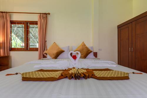 a bedroom with a bed with a swan on it at Green Garden House in Ao Nam Mao