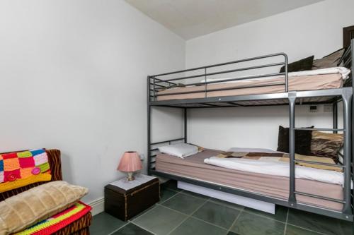 a bedroom with two bunk beds and a couch at Slemish Barn Hostel in Ballymena