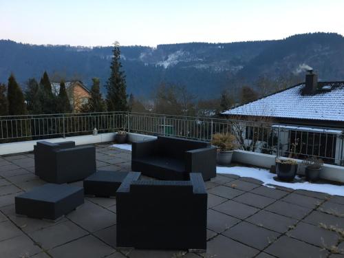 a patio with couches and a balcony with snow at Bella Villa in Traben-Trarbach