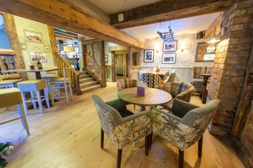 a living room with a table and chairs at Cross Keys by Chef & Brewer Collection in Nunthorpe