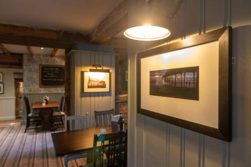a restaurant with a picture hanging on the wall at Cross Keys by Chef & Brewer Collection in Nunthorpe