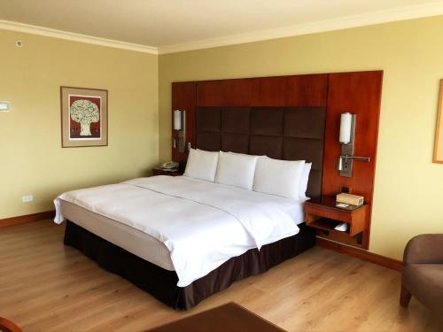 a bedroom with a large bed in a hotel room at Swissotel Quito in Quito