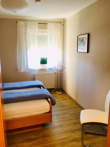 a bedroom with a bed and a window at Ferienwohnungen Panorama Harrys Bike Tours in Villach