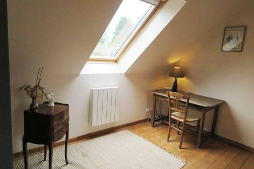a attic room with a desk and a window at Les Gîtes de Douar Bouillon in La Chapelle-Neuve