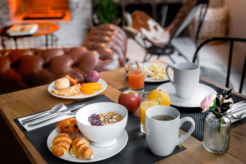 a table topped with plates of breakfast foods and coffee at 9Hotel Bastille-Lyon in Paris