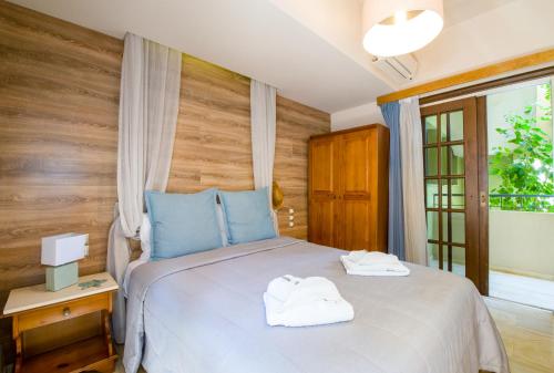 a bedroom with a bed with two towels on it at Evangelos Apartments in Platanias