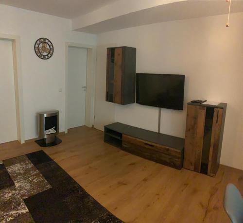 a living room with a flat screen tv on a wall at Apartment Altstadt in Pirna