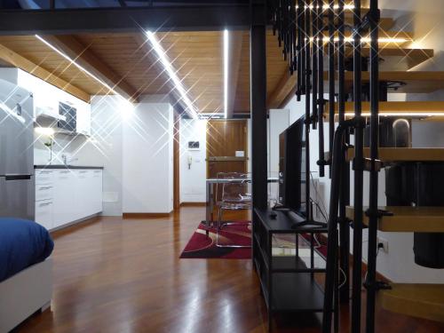 ein Wohnzimmer mit einer Treppe und eine Küche in der Unterkunft Giudei House Suite Bologna in Bologna