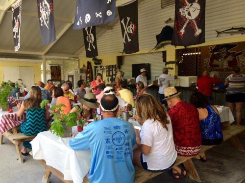 a group of people sitting at tables in a restaurant at Pirates Pointe Resort in Ruskin