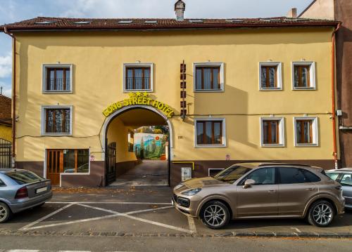 a car parked in front of a building at Long Street Hotel in Braşov