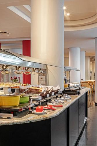 a large kitchen with many dishes on a counter at Rede Andrade Braz in Curitiba