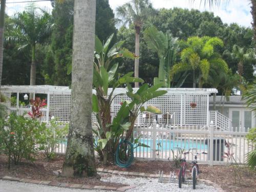 a resort with a pool and some trees and a fence at Pirates Pointe Resort in Ruskin
