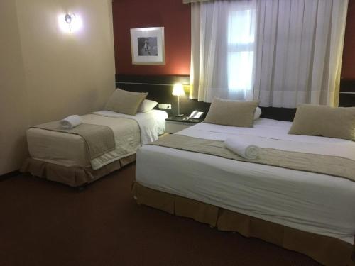 Letto o letti in una camera di leclub resort hotel