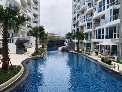 a swimming pool in the middle of a resort at Luxury Business Suits in Grand Avenue by Pattaya City Estates in Pattaya