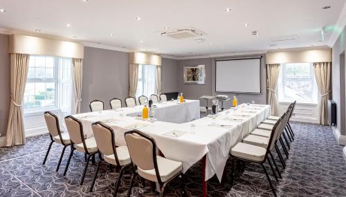a conference room with a long table and chairs at The Devon Hotel in Exeter