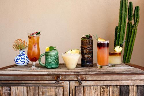 a group of drinks on top of a wooden table at Fairmont Scottsdale Princess in Scottsdale