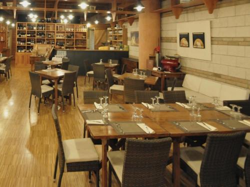 a restaurant with wooden tables and chairs in a room at Osteria Della Posta in Poggio Picenze