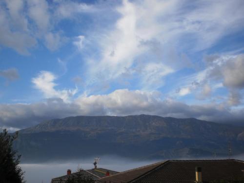 a view of a mountain under a cloudy sky at Osteria Della Posta in Poggio Picenze