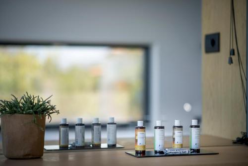 a group of bottles of essential oils sitting on a table at OPENNESS House by the sea in Marathi
