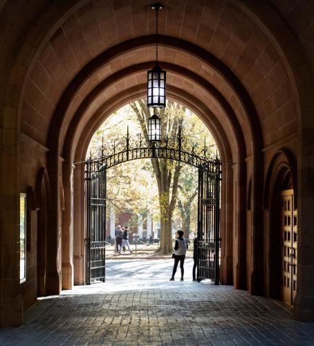 a woman walking through an archway in a building at Graduate by Hilton New Haven in New Haven