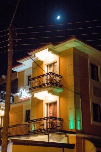 a building with balconies and a moon in the sky at Yiannis Apartments in Ioannina