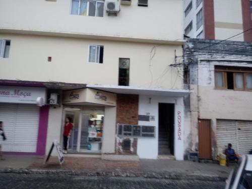 a person standing in the doorway of a building at Pousada bandeirantes in Ilhéus