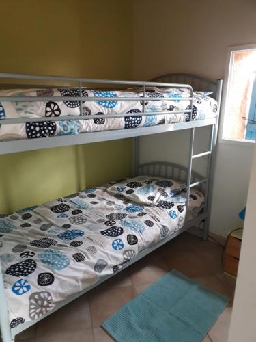 two bunk beds in a room with a bed at Gite de Pêche in Pont-de-Poitte