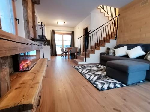 a living room with a couch and a fireplace at Nova Lodge in Livigno