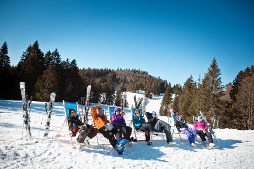 a group of people posing for a picture in the snow at Résidence Les Grandes Feignes in La Bresse