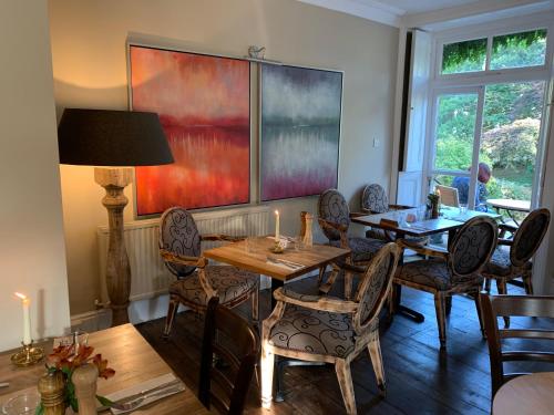 a dining room with a table and chairs at Scarborough Hill Country Inn in North Walsham