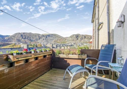 a balcony with chairs and a view of the mountains at Hendre in Blaenau-Ffestiniog