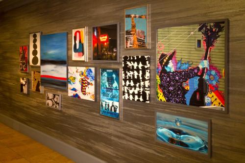 a wall with paintings and pictures on it at Silver Cloud Hotel - Seattle Broadway in Seattle