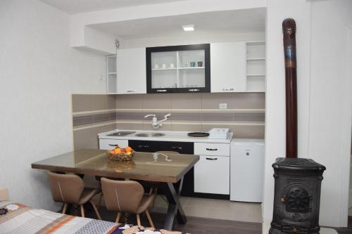 a kitchen with a table and a sink and a stove at Markos Towers Apartments in Prilep