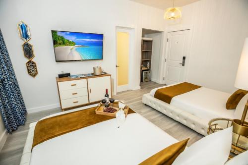 a bedroom with two beds and a tv at Catalina Hotel & Beach Club in Miami Beach