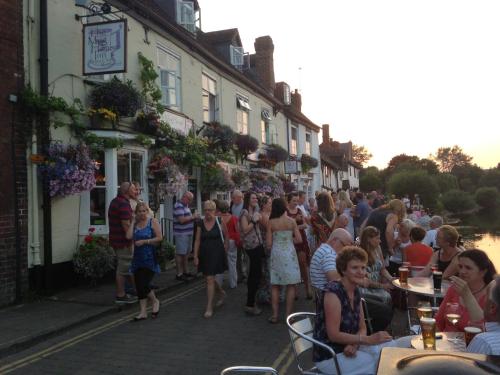 a crowd of people walking down a street at The Mug House Inn in Bewdley