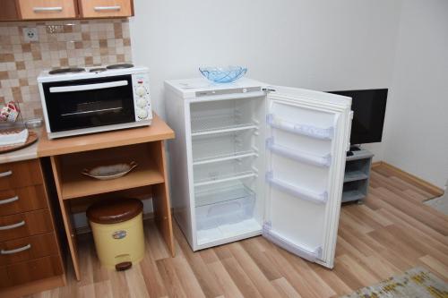 a kitchen with an open refrigerator and a microwave at Markos Towers Apartments in Prilep