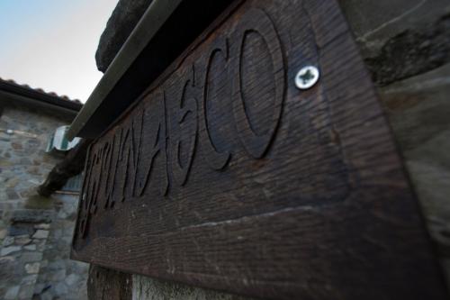 a close up of a wooden sign on a building at Giunasco in Bagnone