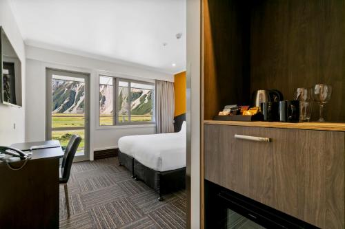 a hotel room with a bed and a window at Mt Cook Lodge and Motels in Mount Cook Village