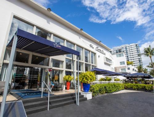 a large white building with a blue awning at Catalina Hotel & Beach Club in Miami Beach