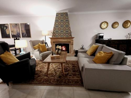 a living room with a couch and a fireplace at Vogue 23 Boutique Villa Cascais in Cascais
