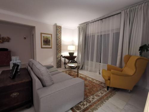 a living room with a couch and two chairs at Vogue 23 Boutique Villa Cascais in Cascais