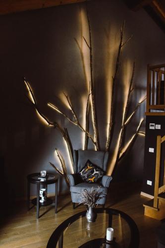 a living room with a tree mural on the wall at The Cozy Nest - Bellano in Bellano